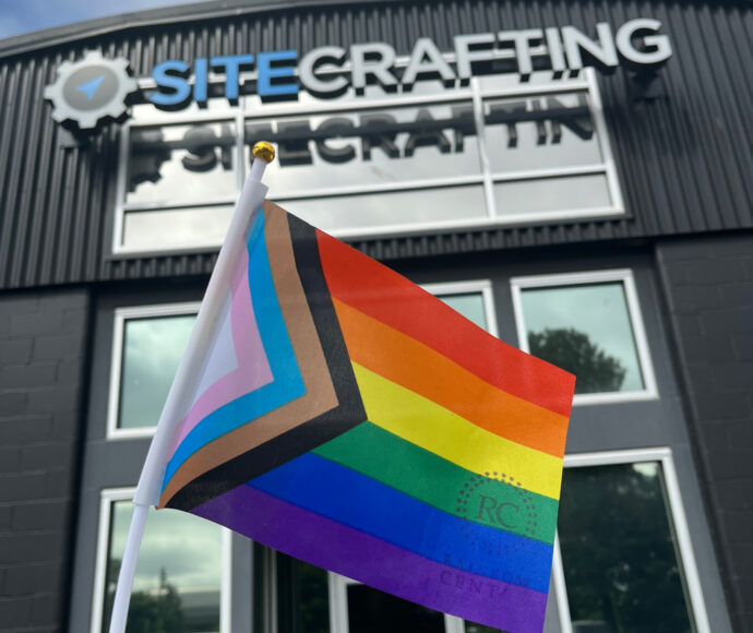 Pride flag in front of SiteCrafting office building
