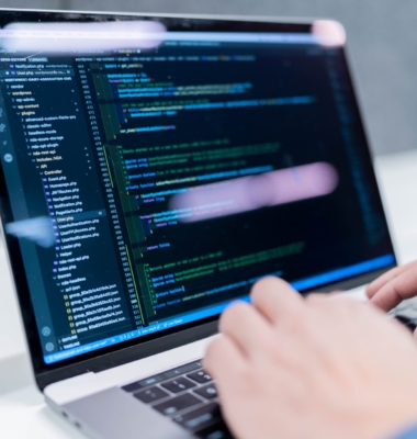 Closeup of a SiteCrafting team member coding on their laptop