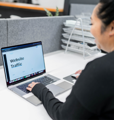 Angie Carson reviewing a website traffic report on her laptop
