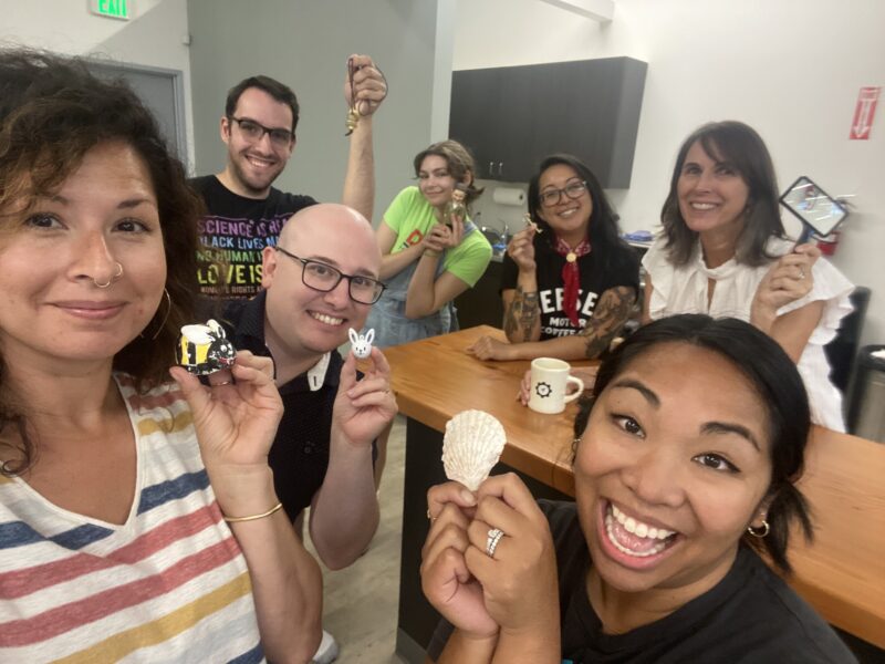 SiteCrafting team poses with items used in an improv activity
