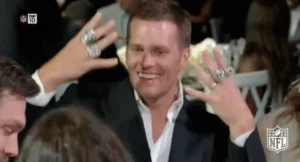 GIF of Tom Brady waving all of his superbowl rings on his hands
