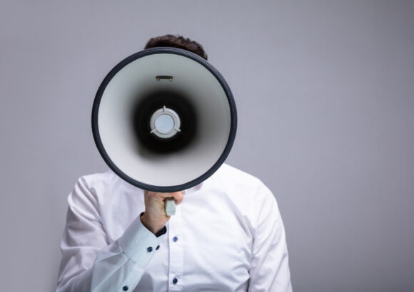 Man speaking into a megaphone.